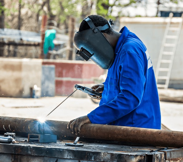 african worker welding outdoors factory 600nw 1218970240
