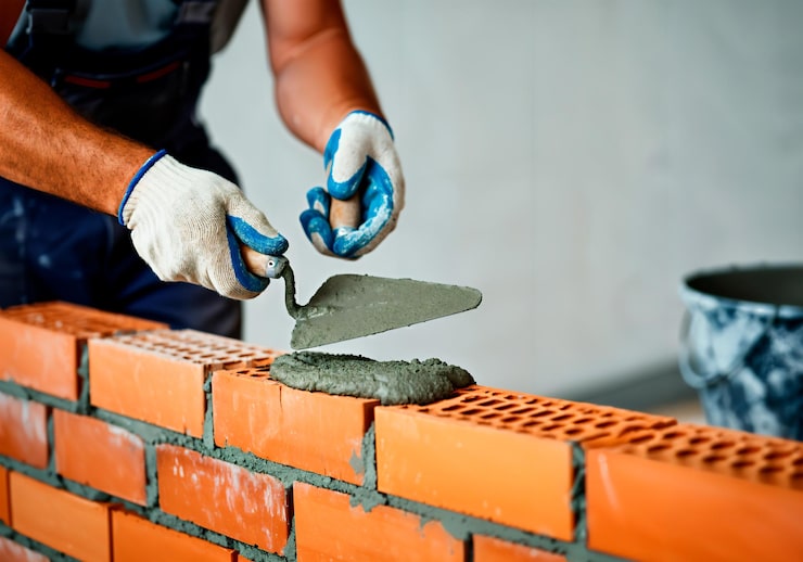 person wearing gloves that is brick wall 208571 161